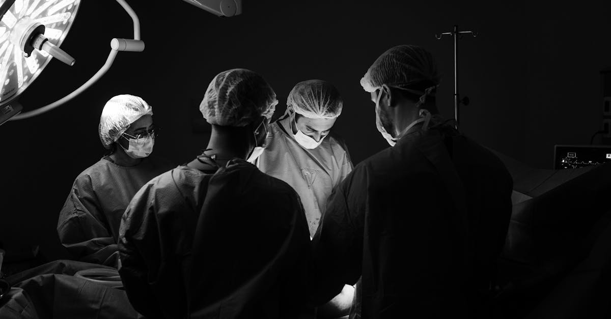 A group of surgeons in an operating room, focusing intently during a procedure.